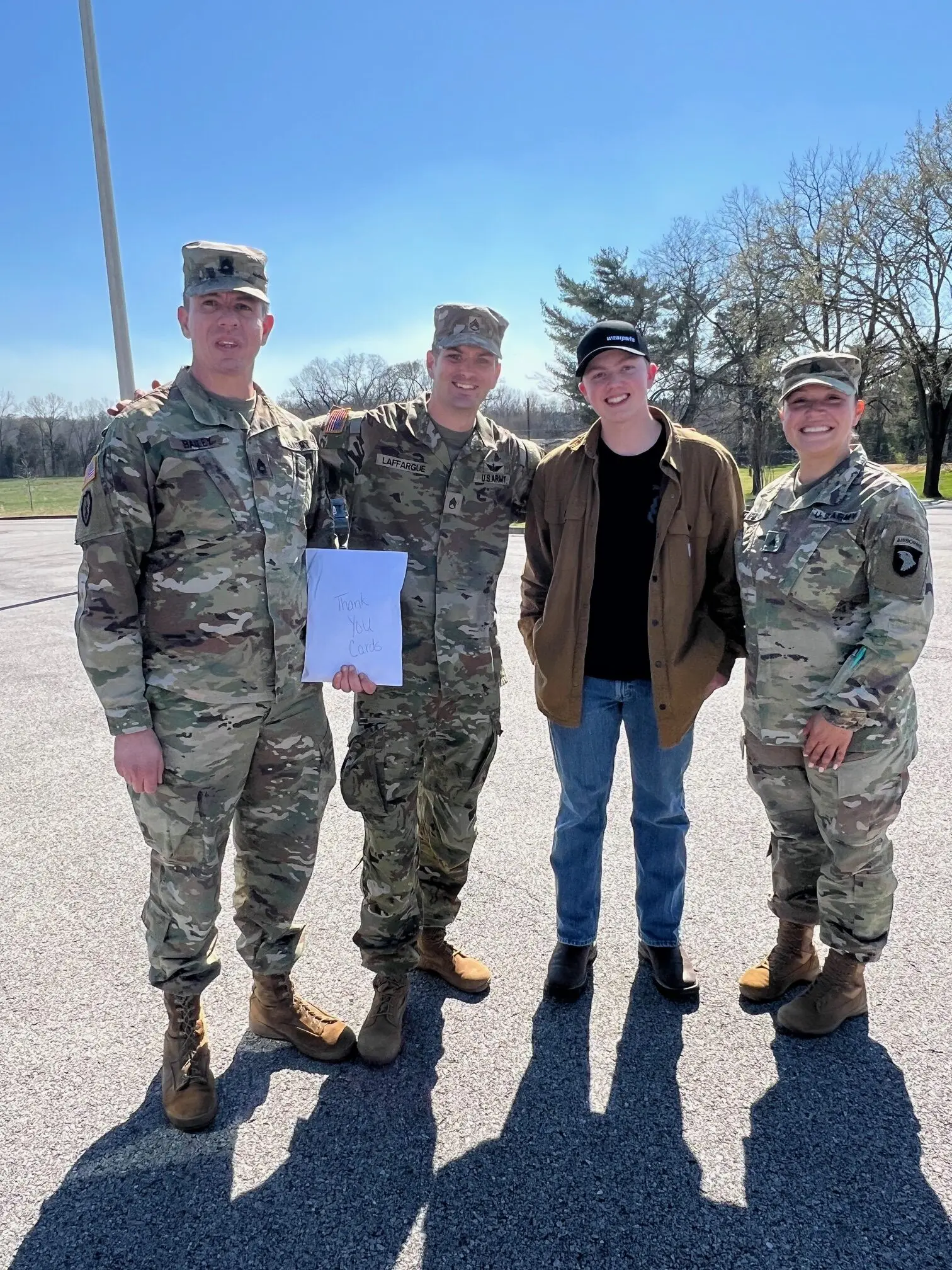 man with three people in the Army