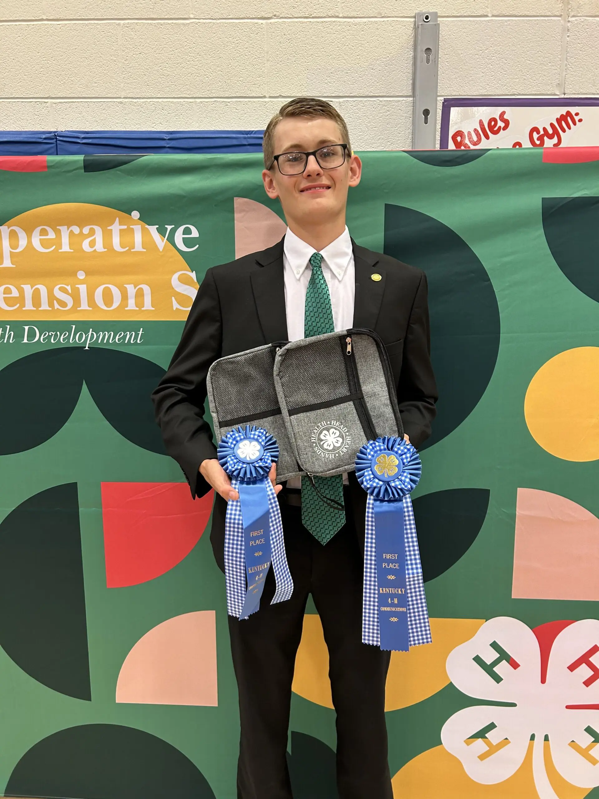 Boy getting award ribbons from | Kentucky 4-H Youth Advocacy Program