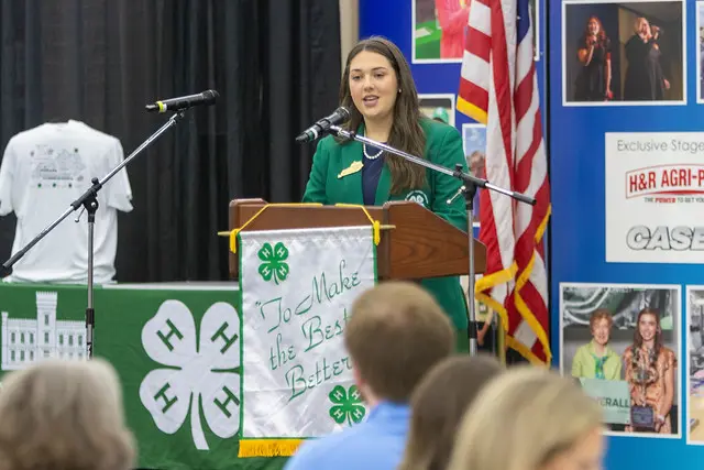 woman giving speech at podium to audience | Kentucky 4-H Youth Advocacy Program