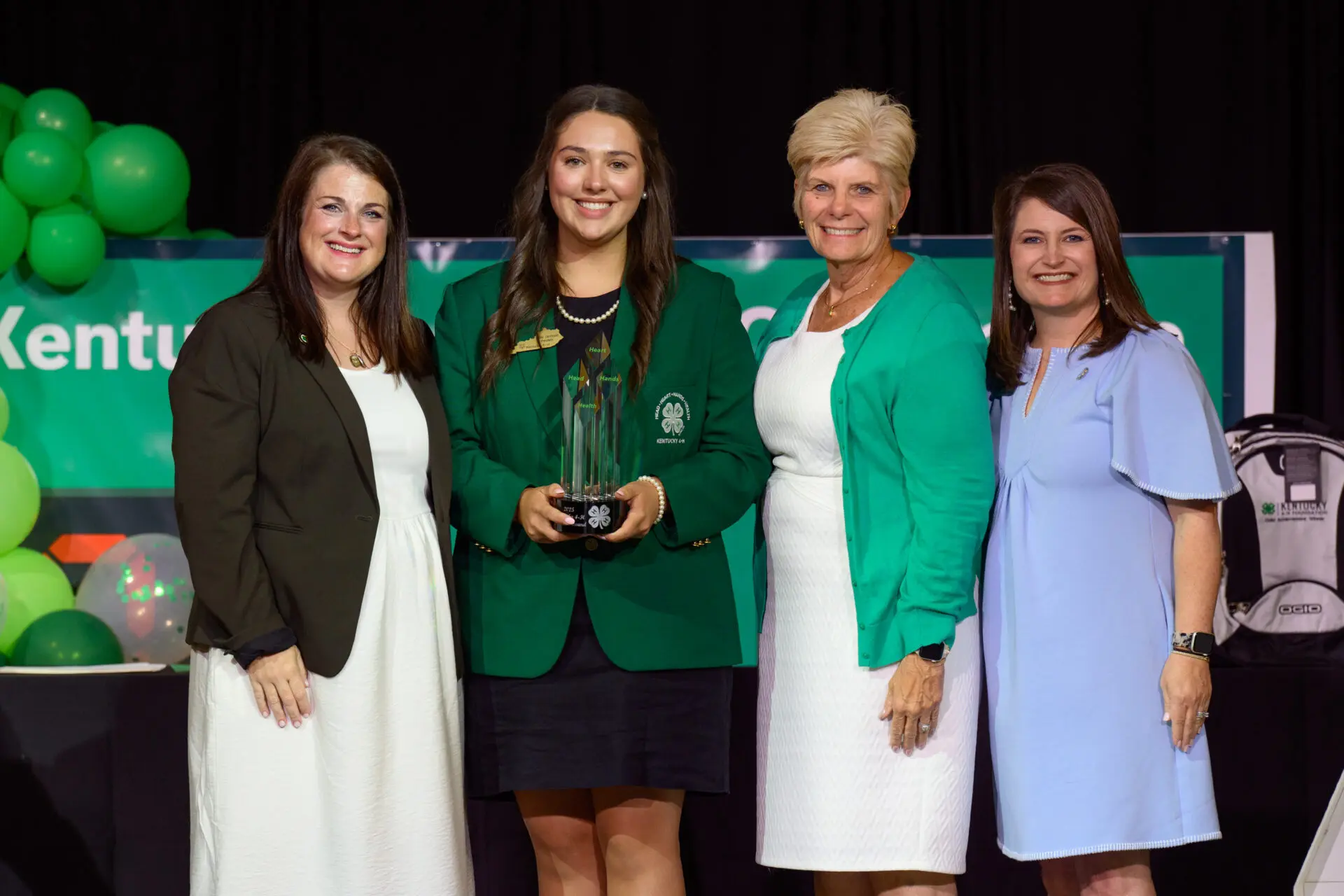 teen girl getting a trophy from Kentucky 4-H foundation
