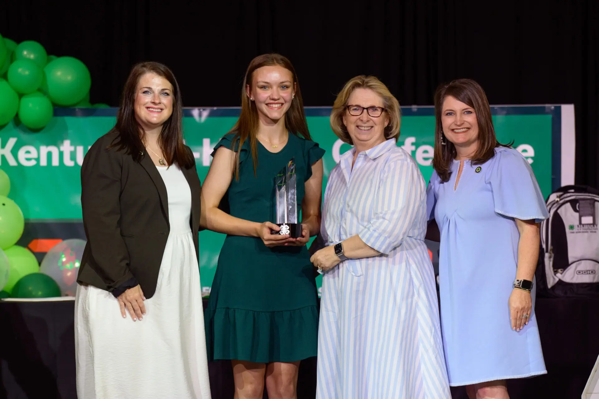 women giving an award to girl at Kentucky 4-H