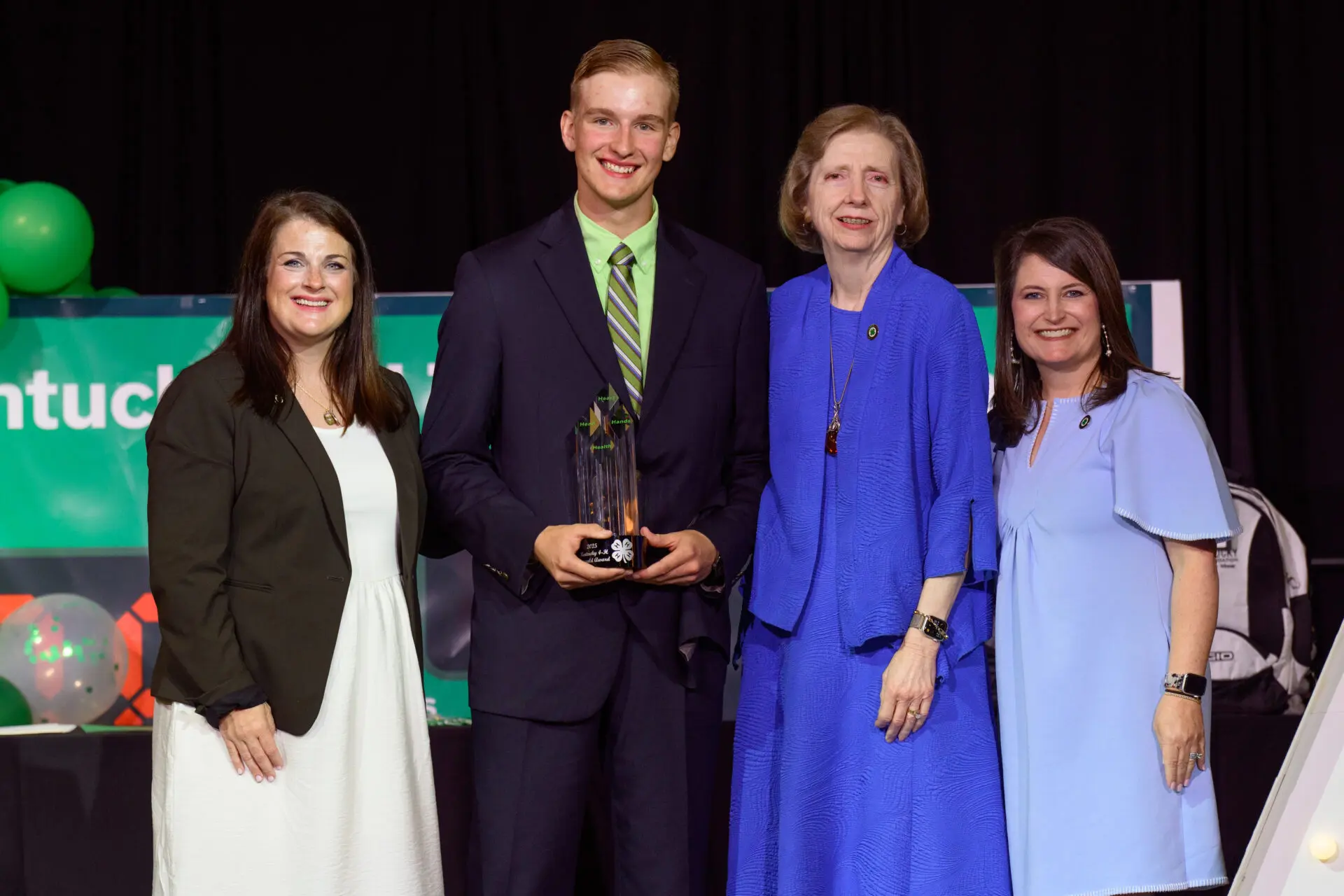 group of 4 people getting a trophy