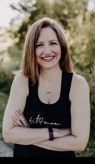 mom posing with tree in background